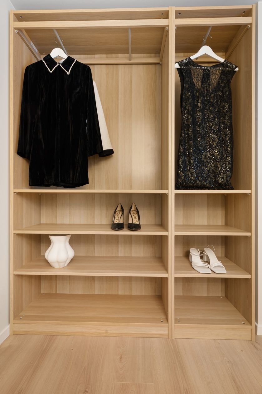 Open wardrobe interior with organised hanging space and shelving — ARM Builds IKEA PAX wardrobe assembly, Manchester
