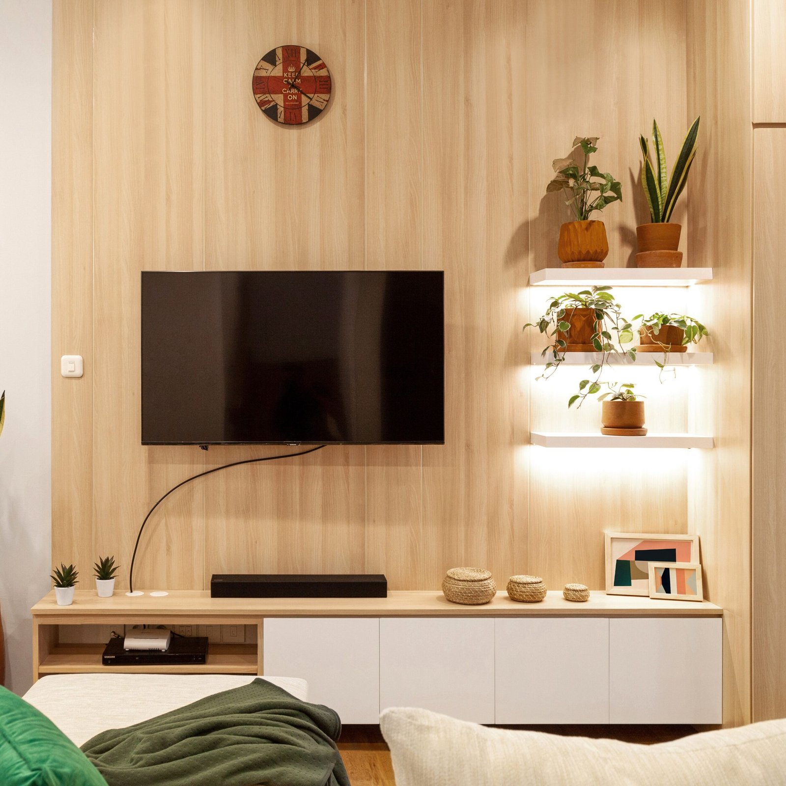 Flat-screen TV mounted on a wood-panelled wall with the cable routed neatly — ARM Builds Manchester